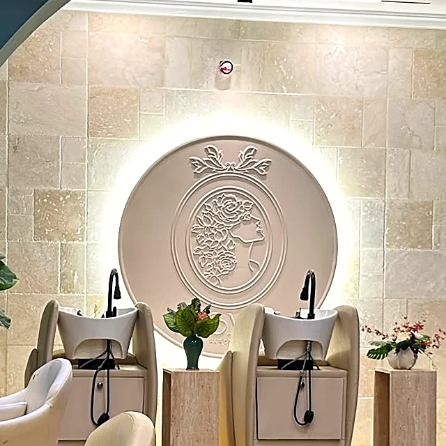 The Promise cameo, backlit in plaster above the wash basins