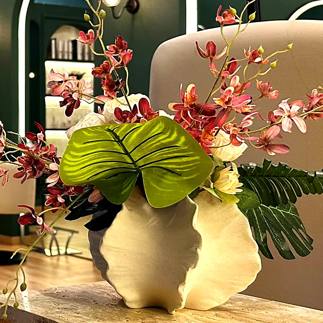 Orchids on a travertine plinth in the salon